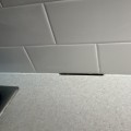 Do you leave a gap between a countertop and backsplash?