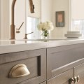 Should cabinet hardware match faucet or light fixture?
